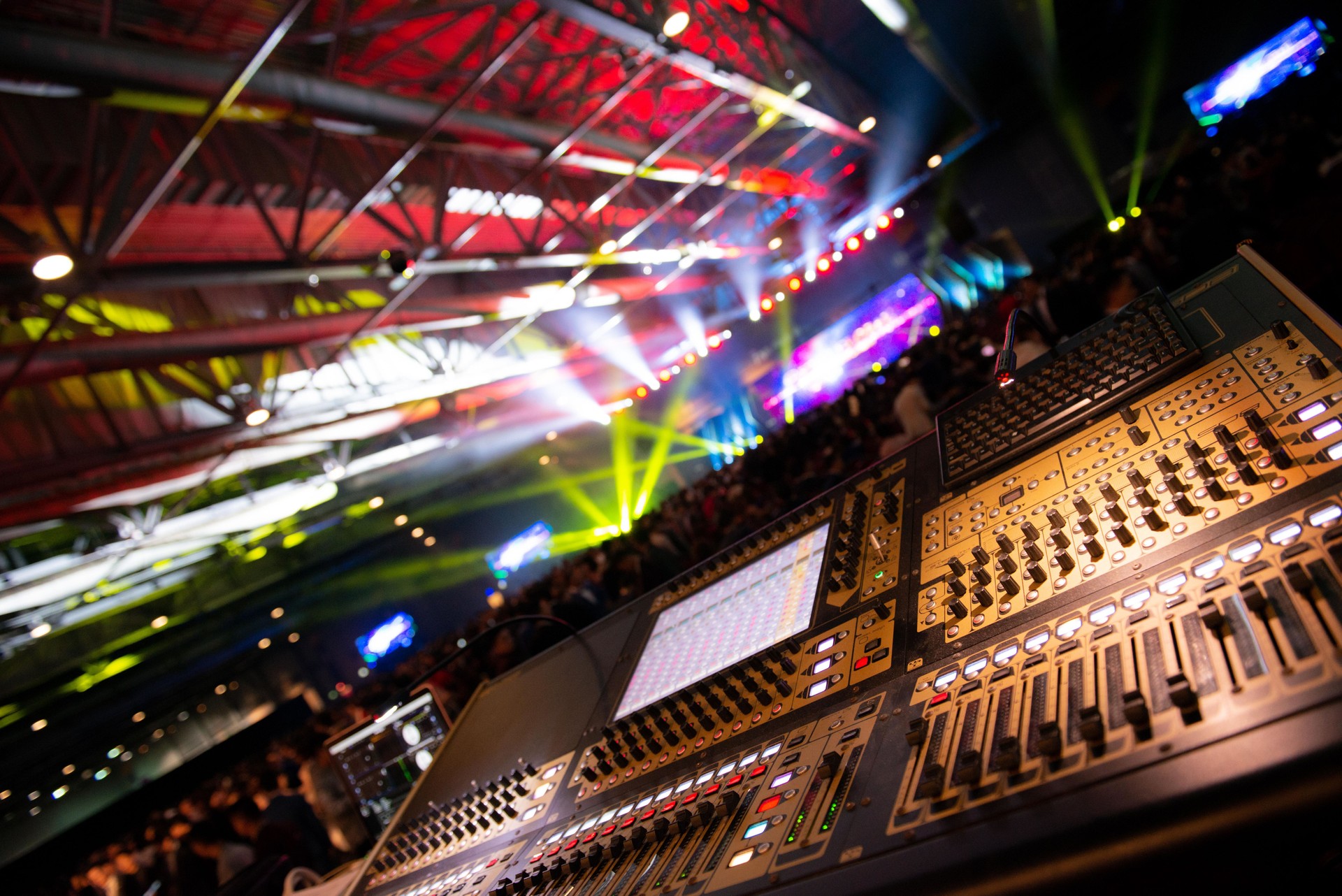 Sound mixer. Audio equalizer with lighting effect background. Production at a live music concert event.